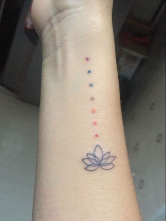 A small tattoo of a lotus flower on the wrist.