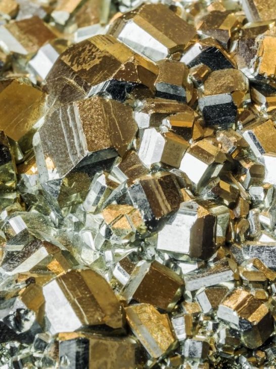 A close up of a pile of gold and silver crystals.