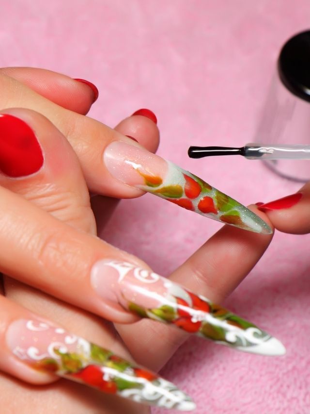 A woman is getting her nails done by a nail artist.