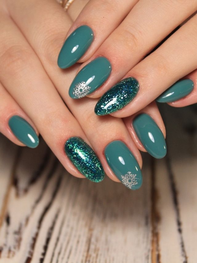 A woman's hands with green and silver nails.