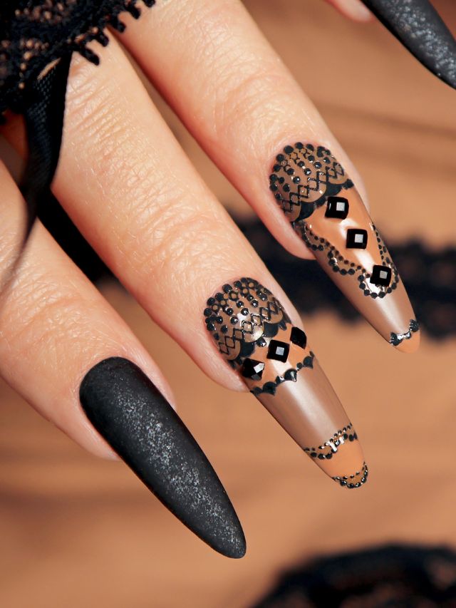 A woman's nails with black and white designs.