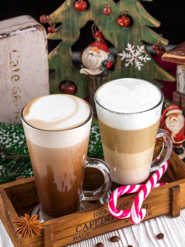 Two cups of coffee on a wooden tray with candy canes.