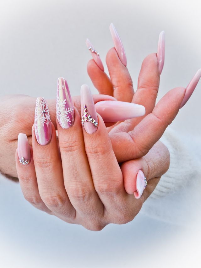 A woman's hands with pink and white nails.