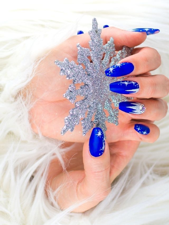 Dark blue and white Christmas snowflake airbrushed nail design