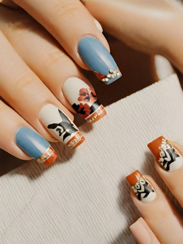 A woman with blue and orange nails with floral designs.