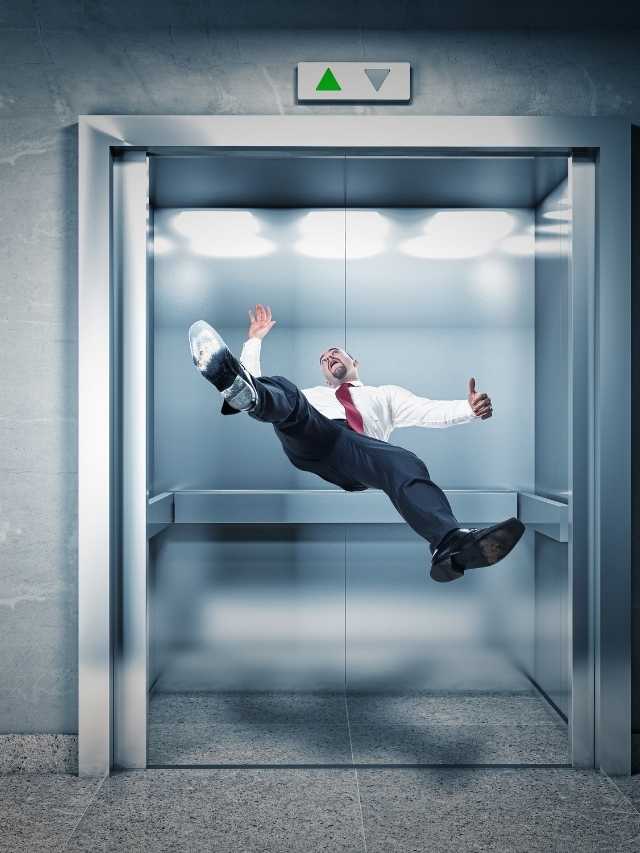 A businessman jumping out of an elevator.