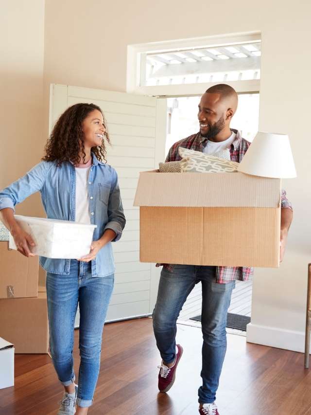 A man and woman moving into a new home.
