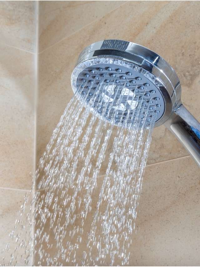 A shower head with water coming out of it.