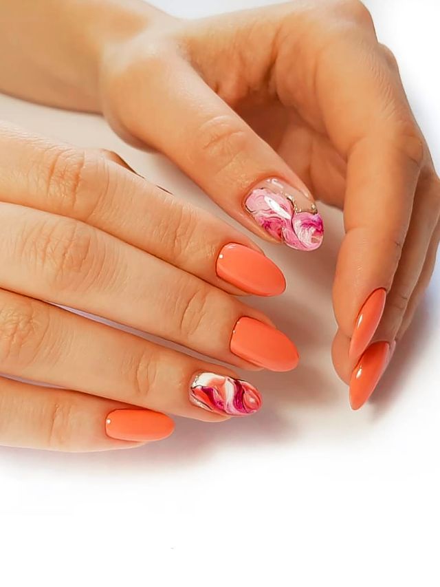 A woman's hands with orange and pink nails.
