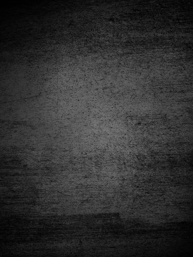 A black wooden background with some scratches.