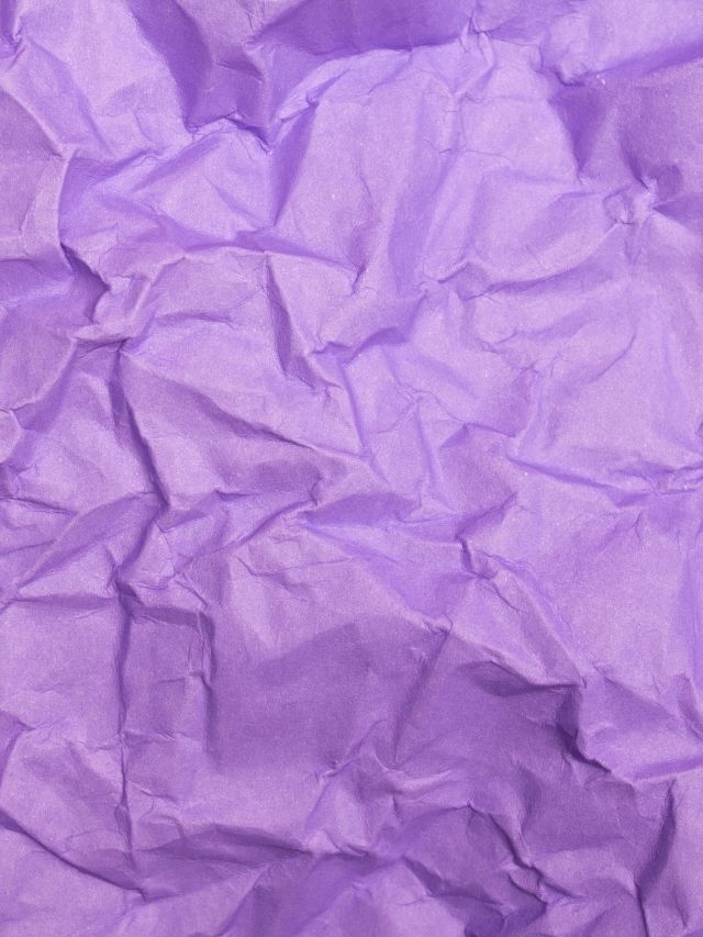 Purple crumpled paper background.