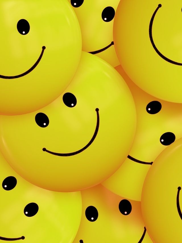 A group of yellow smiley faces with black eyes.