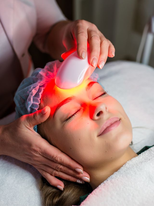 A woman is receiving a facial treatment at a beauty salon to discover what is a Photo Facial.