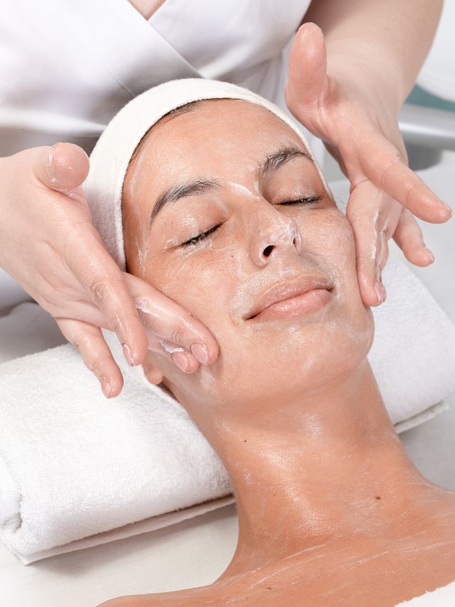 A woman experiencing a facial treatment at a spa.