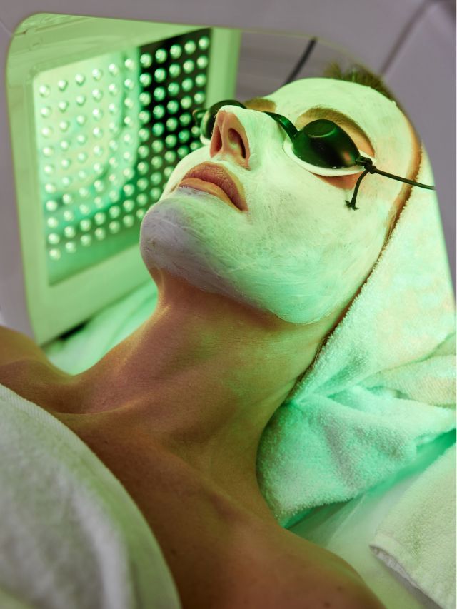 A woman is getting a facial treatment in a spa.