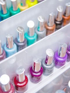 Colorful nail polish bottles in a white tray.