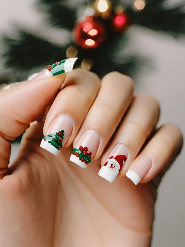 A woman is holding up a christmas manicure with a santa claus on it.