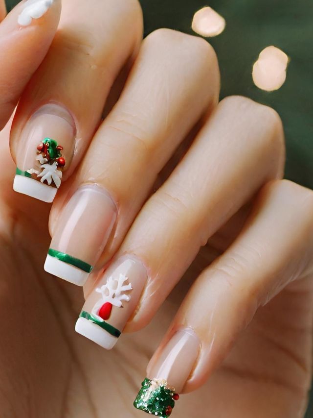 A woman is holding up her nails with christmas decorations on them.