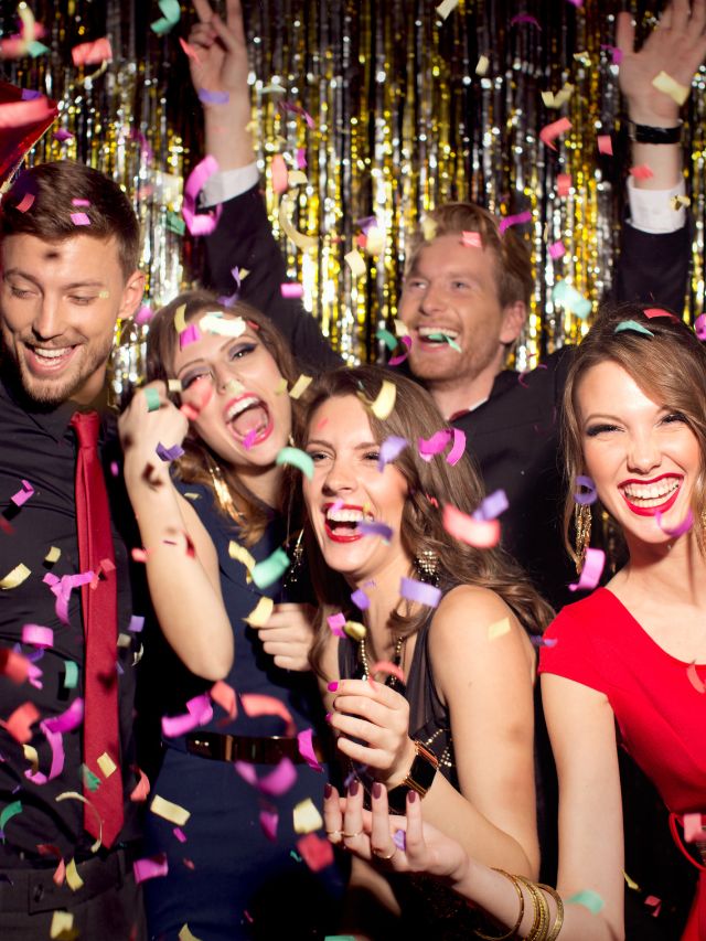 A group of people having fun at a party with confetti.