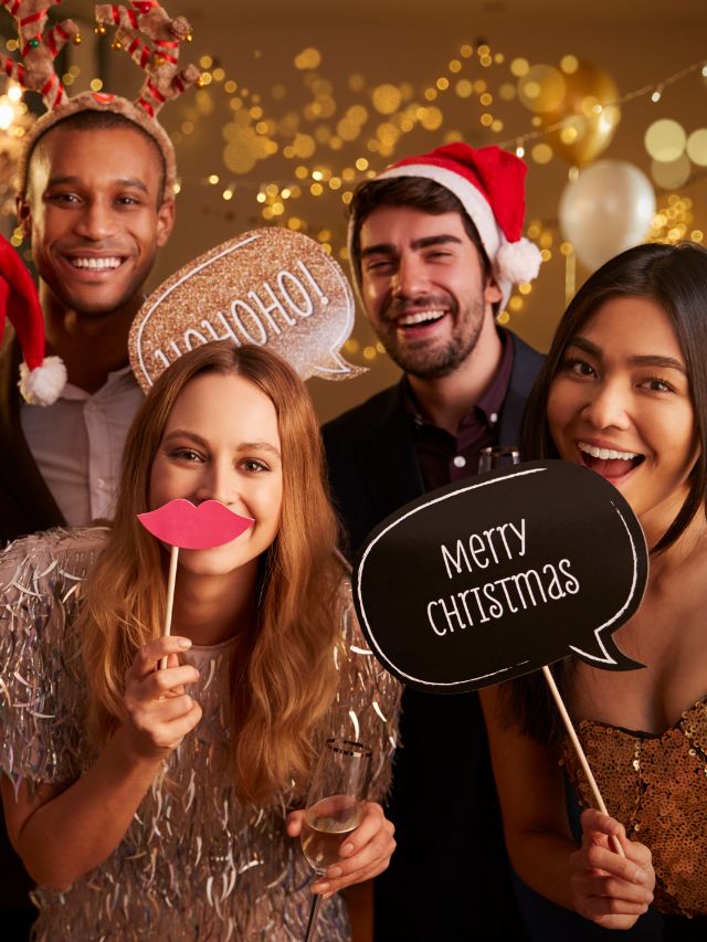 A group of friends posing for a photo at a christmas party.
