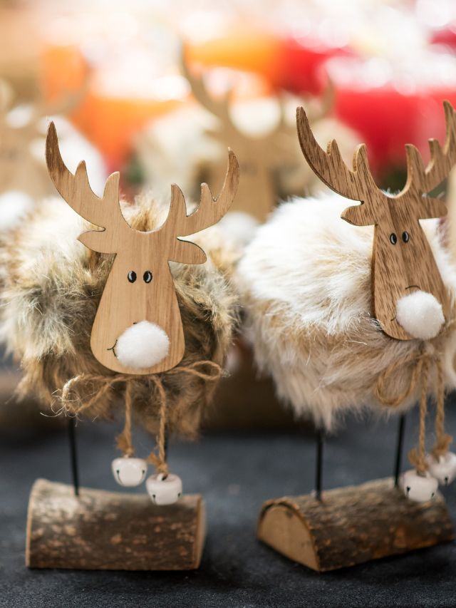 A group of wooden reindeer figurines on a table.