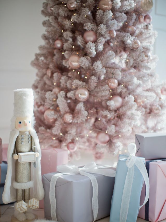 A christmas tree with presents and a nutcracker in pink christmas party