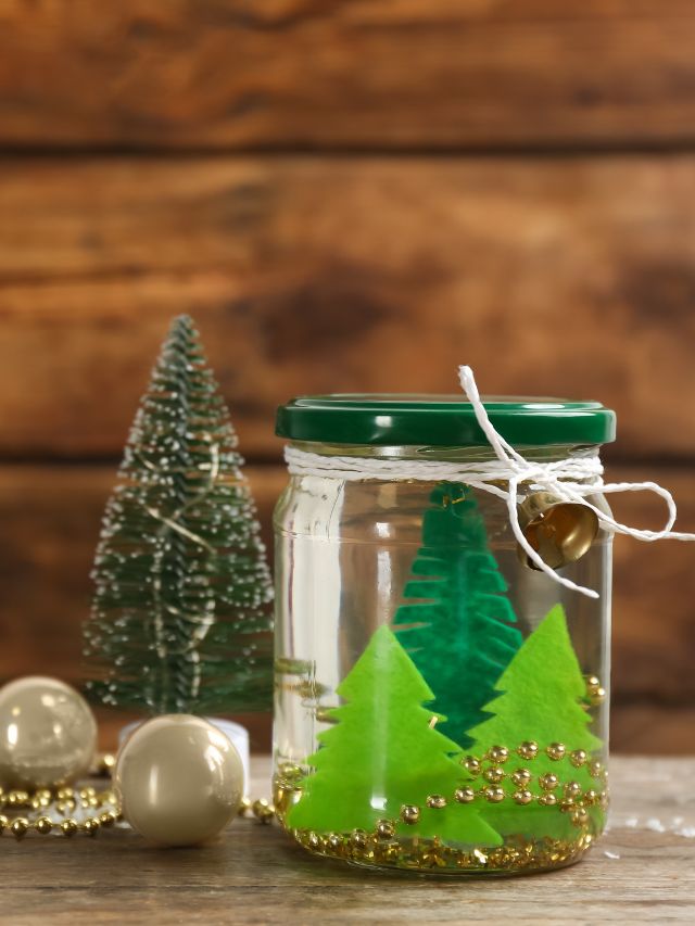 A glass jar with a christmas tree in it.
