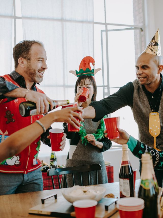 A group of people toasting at a christmas party.