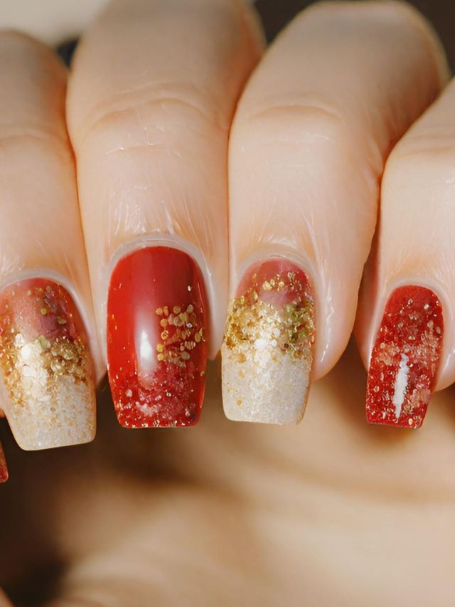 A woman's nails with red and gold glitter on them.