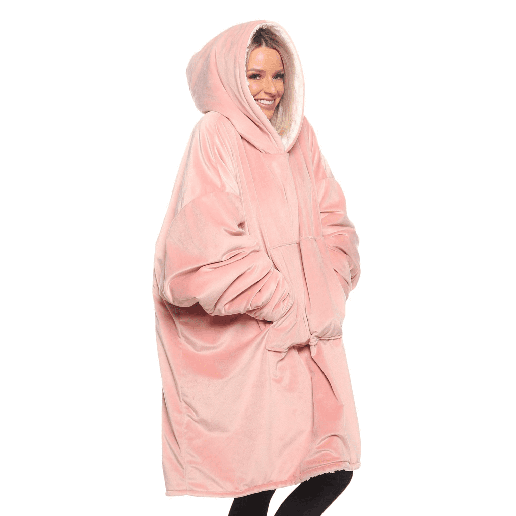 A woman wearing a pink hooded robe, providing cozy Christmas gift ideas for elderly parents.
