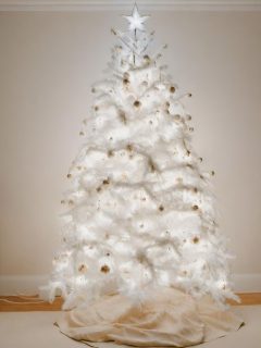 A modern white christmas tree adorning a room.
