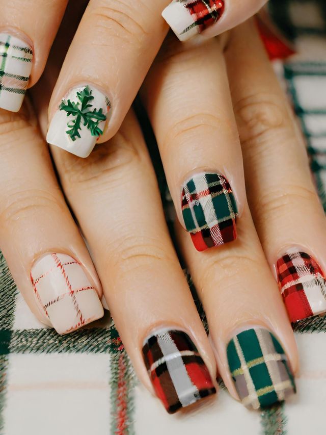 A woman's nails with plaid designs on them.