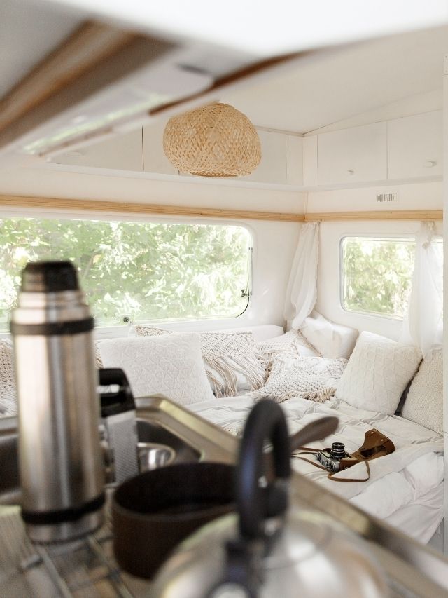 The interior of a camper van with a stove and sink.