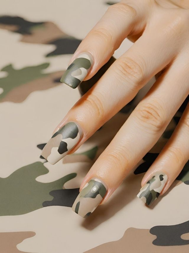 A woman's hand with camouflage nails.