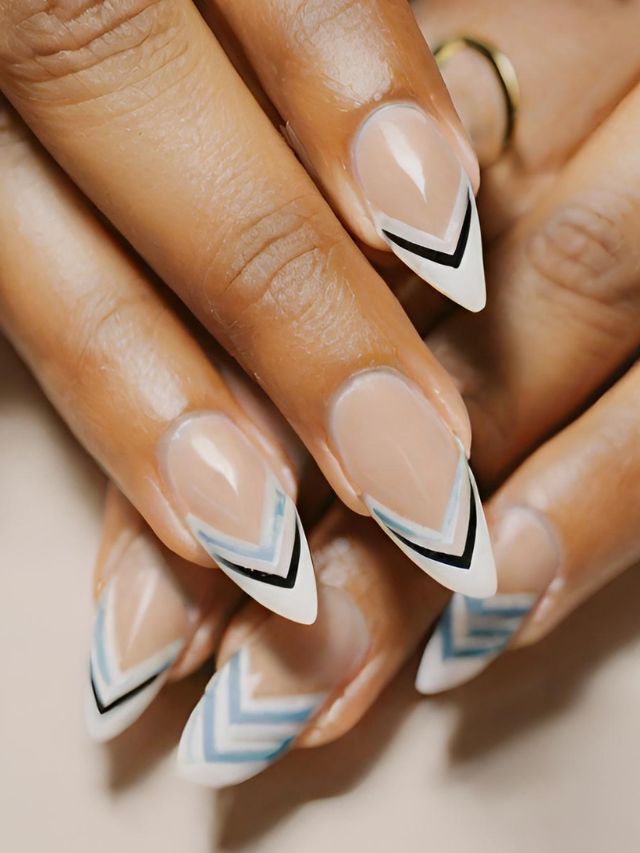 A woman's nails with a blue and white chevron design, showcasing stunning chevron nail designs.