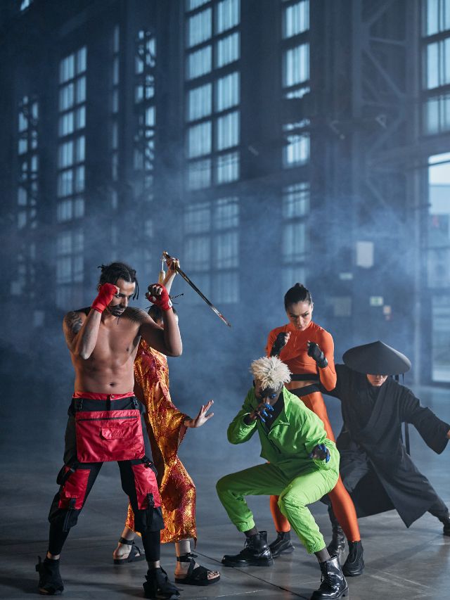 A group of people dressed in ninja costumes in a warehouse.