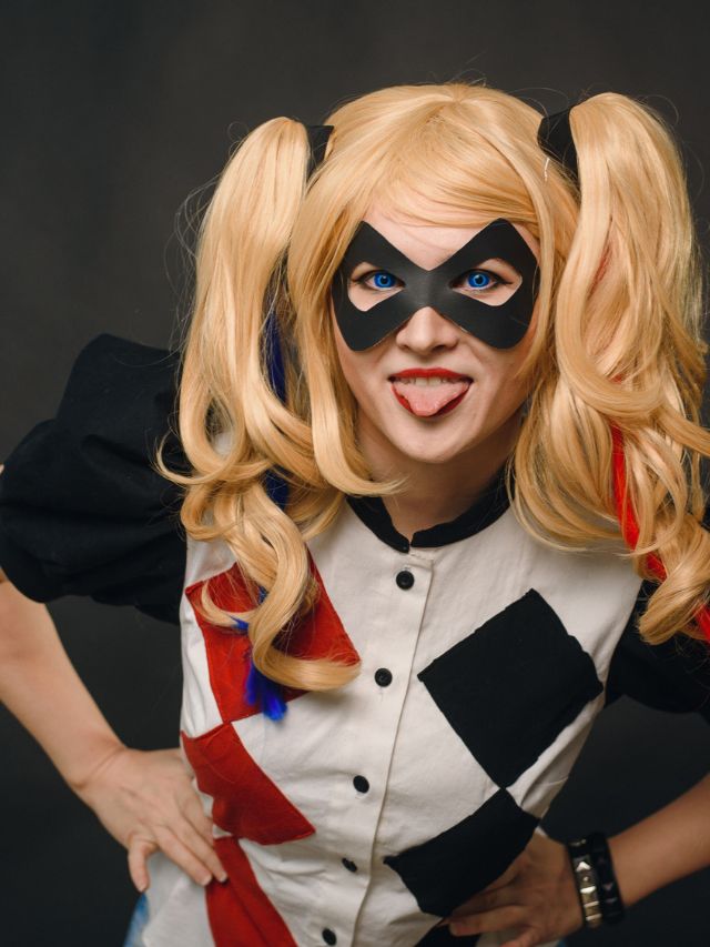 A woman in a harley quinn costume posing for a photo.