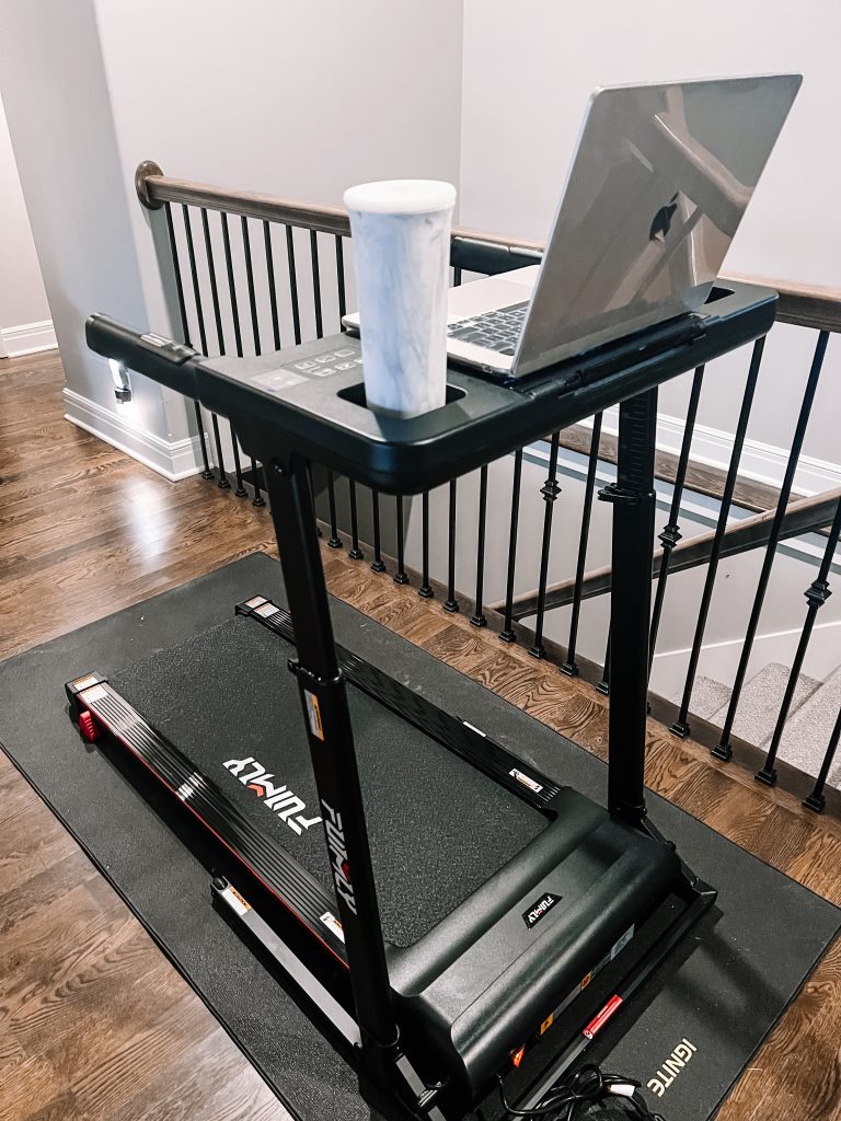 A treadmill with a laptop on top of it.