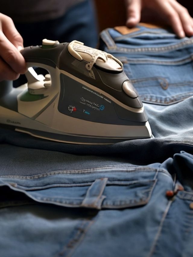 A person is ironing a pair of jeans.