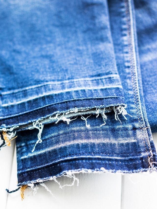 A pair of blue jeans with holes in them.