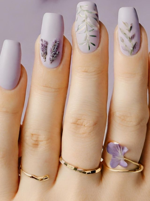 A woman's hands with lavender nails and rings.