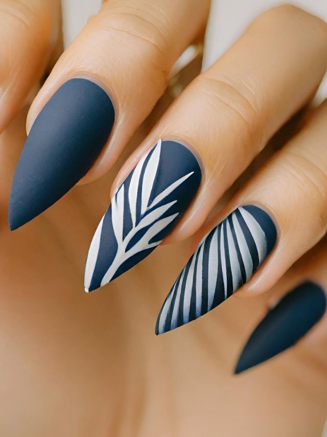 A woman's nails with a black and white design.