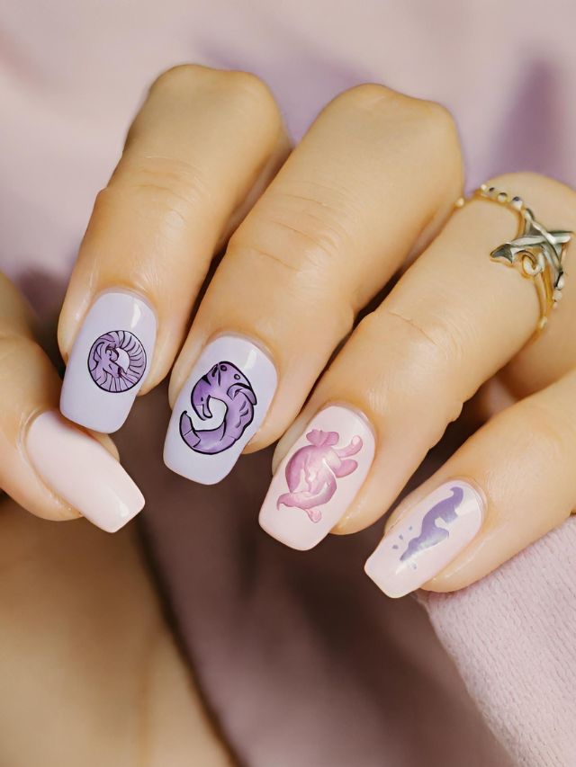 A woman's nails are adorned with a mesmerizing mermaid design underwater.