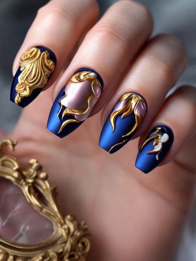 Luxury Nail Designs: A woman's nails adorned with gold and blue designs exude opulence and elegance. These captivating nail ideas are perfect for those seeking a touch of sophistication to elevate their style.