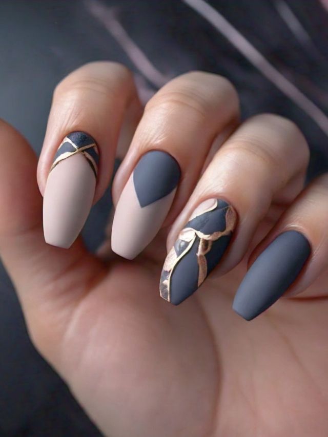 A woman's luxury nails with grey and gold accents, showcasing elegant and creative nail designs.
