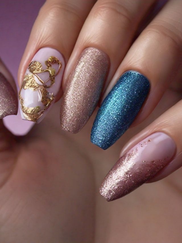 A woman's nails are luxuriously decorated with gold and blue glitter, showcasing stunning nail designs.