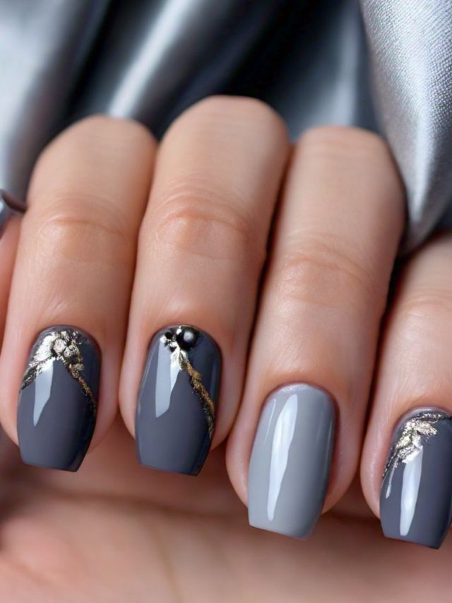 A woman's hand showcasing exquisite nail designs with luxurious gold accents.