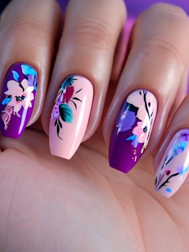 Purple and pink nails with floral designs in pink, purple, and blue.
