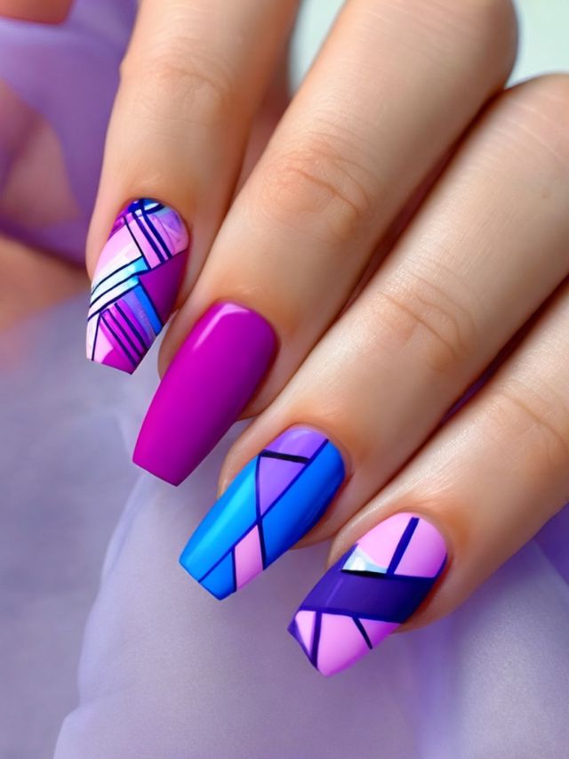 A woman's pink and blue nails with geometric designs in pink, purple, and blue.