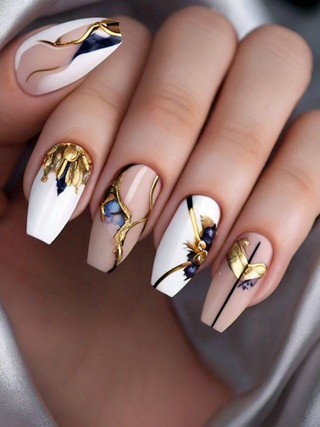 A woman's nails adorned with luxurious gold and white designs, offering captivating ideas for nail designs.